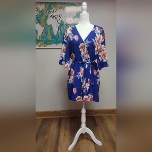 Short navy romper with white and red floral print.